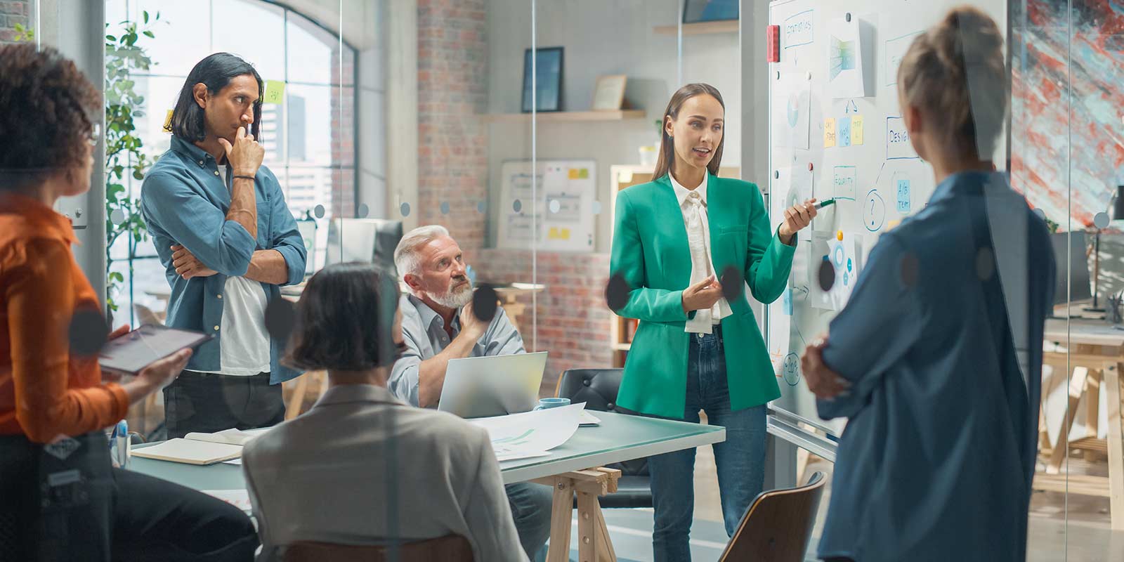 Employees in a meeting in the office talking to each other
