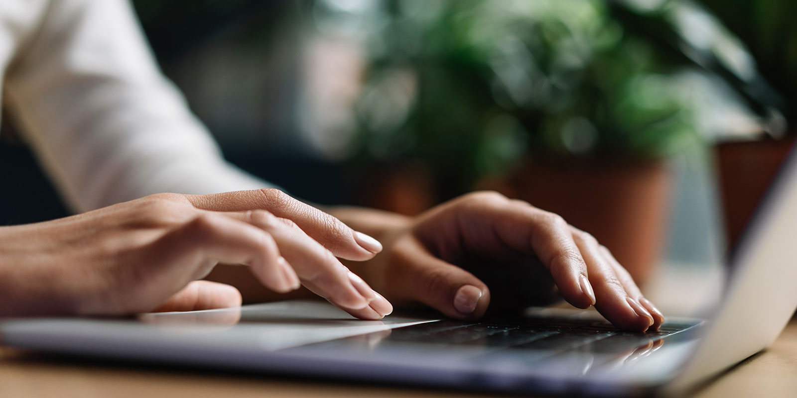 Employee typing on laptop