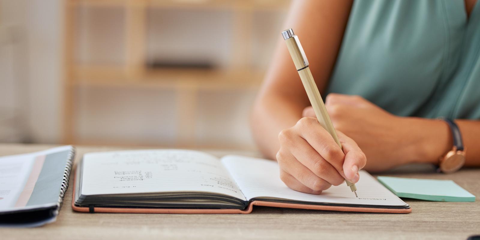 Woman writing at her desk