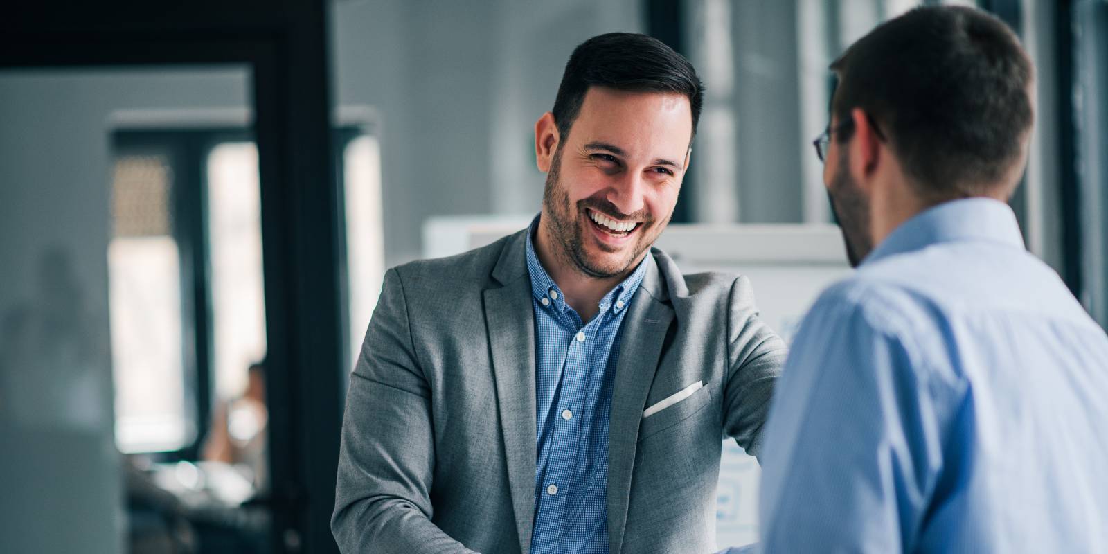 Employees shaking hands at work