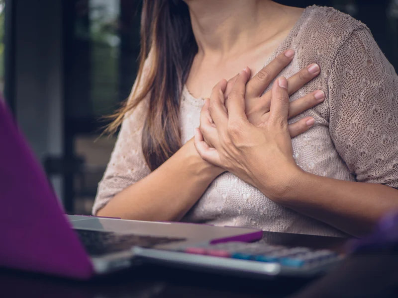 woman indicating chest pain