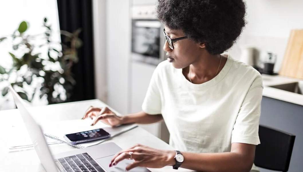 female at desk with laptop