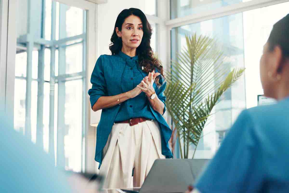 Woman, healthcare speaker or people in presentation or wellness with nurses for research development. Group, teamwork or doctors in meeting for plan, medical review or funding feedback in hospital